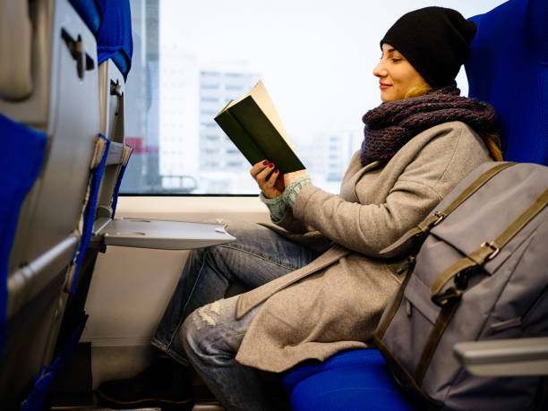 istock Middle aged woman reading a book in MCC train in Moscow 947003232