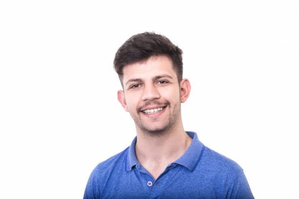 istock Portrait of smiling young man looking at camera over white background 947004288