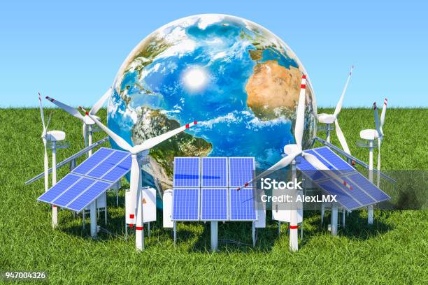 Renewable Energy Concept Solar Panels And Wind Turbines Around The Earth Globe In The Green Grass Against Blue Sky Stock Photo - Download Image Now