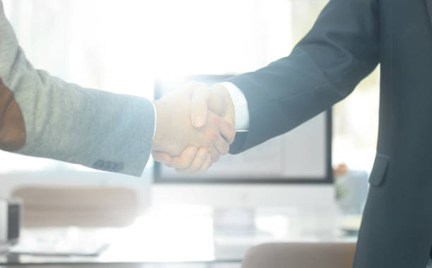 istock closeup .the financial partners shaking hands over a Desk 947009126