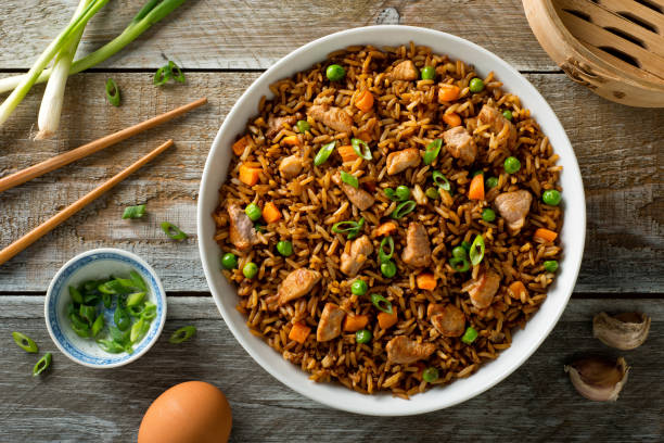 Pork Fried Rice Delicious pork fried rice with egg, carrot, green peas, garlic and green onion. fried rice stock pictures, royalty-free photos & images