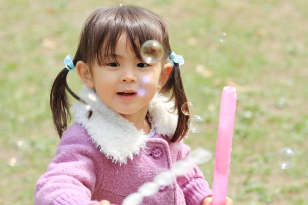 istock Japanese girl playing with bubble (3 years old) 947013926