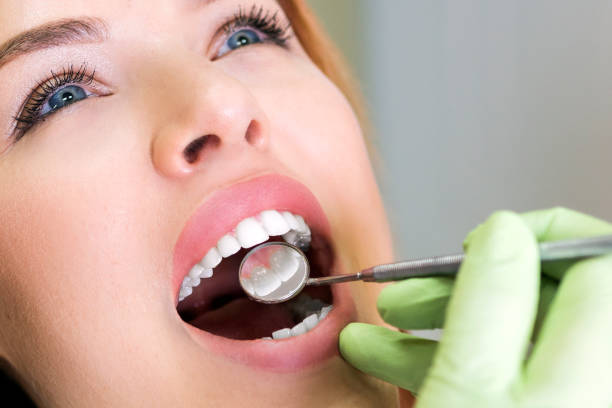 istock Young woman at dentist checking cavities 947017410