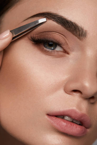 istock Beautiful Woman Plucking Eyebrows. Beauty Brows Correction 947019288