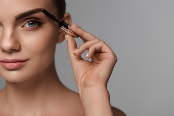 istock Beautiful Woman With Fresh Makeup And Brush For Eyebrows 947021714