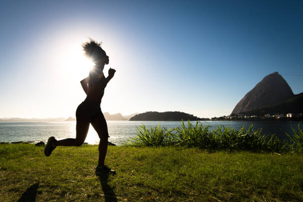 istock Silhouette of Woman Running on Grass 947029808