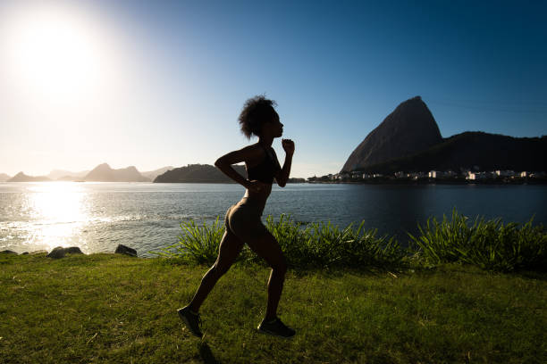 istock Silhouette of Woman Running on Grass 947029894