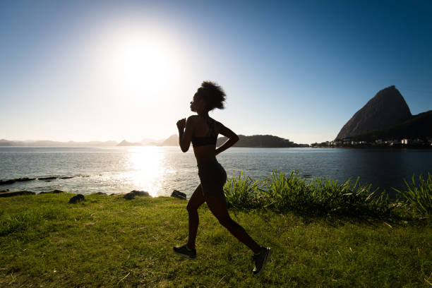 istock Silhouette of Woman Running on Grass 947029956