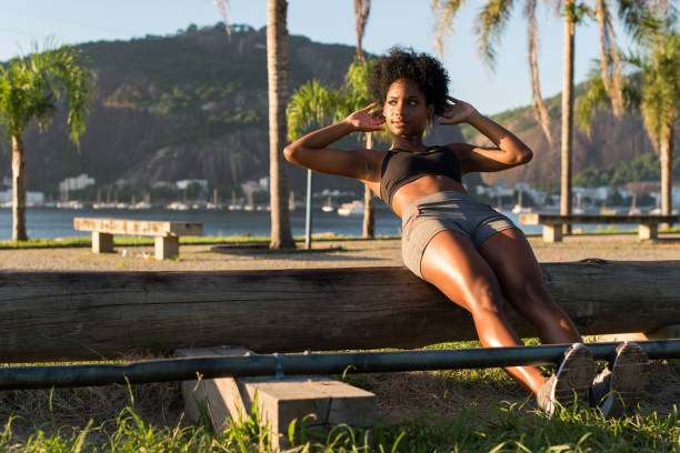 Young Attractive Fitness Woman Doing Sit Ups in Outdoor Gym.