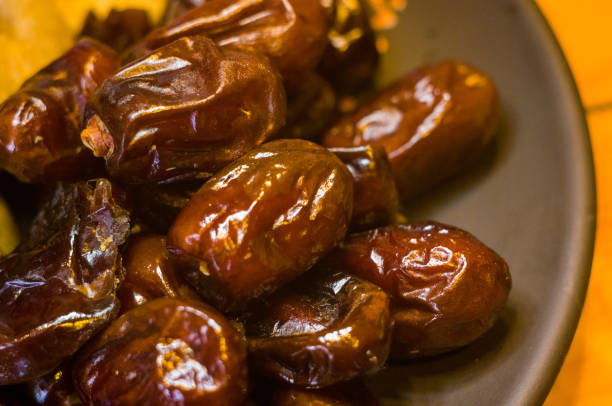 istock dried dates in a ceramic plate on a wooden table 947033318