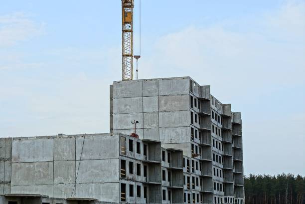 istock unfinished tall house with a tower crane against the sky 947033450