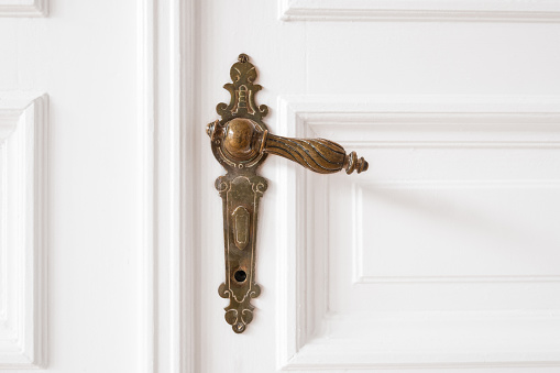 old door handle closeup on wooden door in beautiful apartment - interior