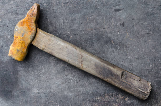istock old rusty hammer on a gray wooden background 947041698