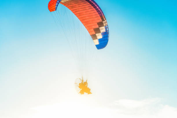 istock Flight on a motor glider in the blue sky with bright backlight sunlight. Solar illumination of the pilot. 947045220