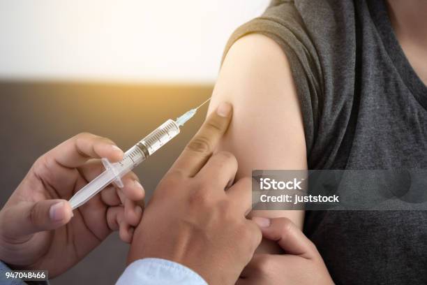 Medicine And Health Care Concept Doctor Giving Patient Vaccine Insulin Or Vaccination Stock Photo - Download Image Now