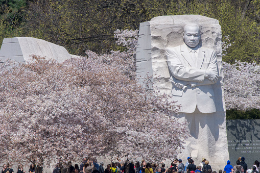 Visitors seem dwarfed by the towering sculpture of Martin Luther King, Jr.at the Tidal Basin in Washingon DC.