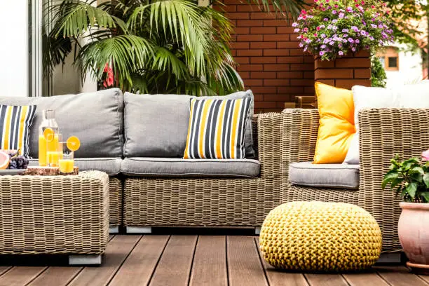 Photo of Yellow pouf on wooden terrace