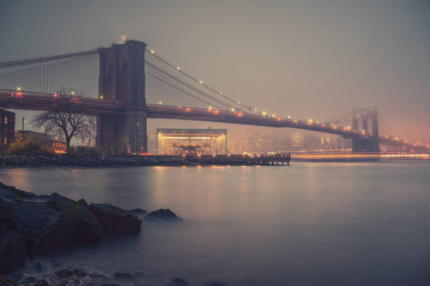 istock Brooklyn bridge at foggy evening 947056062