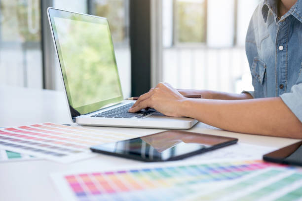 istock Creative creativity graphic designer working with graphics tablet,laptop and smart phone, colour chart at workplace on wooden desk , colour ideas style concept 947061976