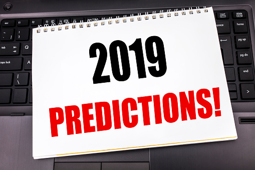 Handwritten text showing 2019 Predictions. Business concept writing for Forecast Predictive written on notepad note paper the black keyboard background.