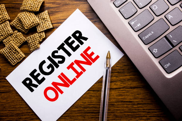 istock Handwriting Announcement text showing Register Online. Business concept for Internet Subscribe written on sticky note paper on the wooden background next to the laptop keyboard 947066390