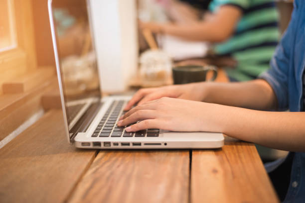 istock Back view of young successful female freelancer use net-book for distance work during her recreation time, woman's hands keyboarding on portable laptop computer with blank copy space on the screen 947068732
