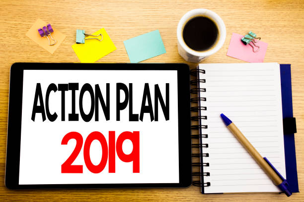 istock Word, writing Action Plan 2019. Business concept for Success Strategy Written on tablet laptop, wooden background with sticky note, coffee and pen 947071982