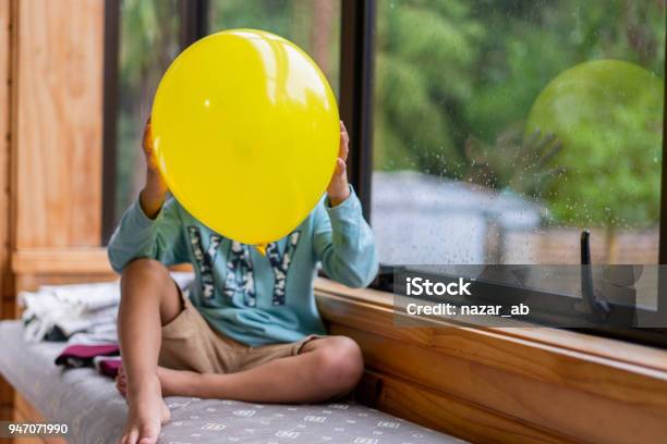 Kid Covering Face With Love Emoji Balloon Stock Photo - Download Image Now - 4-5 Years, Auckland, Balloon