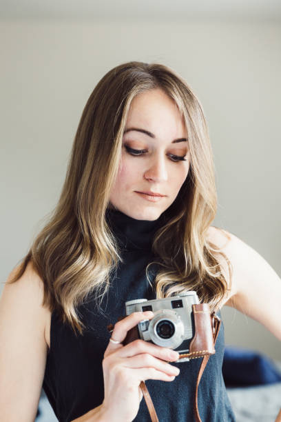 Young woman with vintage camera stock photo