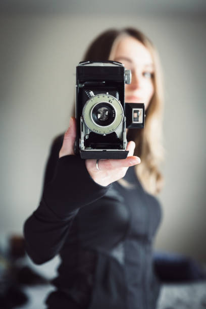 Young woman with vintage camera stock photo