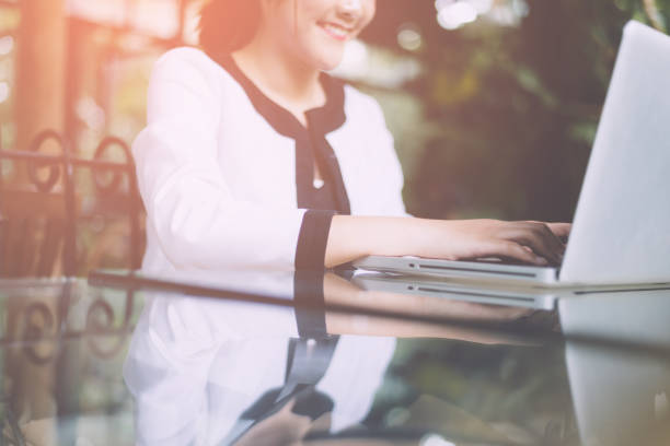 istock Back view of young successful female freelancer use net-book for distance work during her recreation time, woman's hands keyboarding on portable laptop computer with blank copy space on the screen 947081750