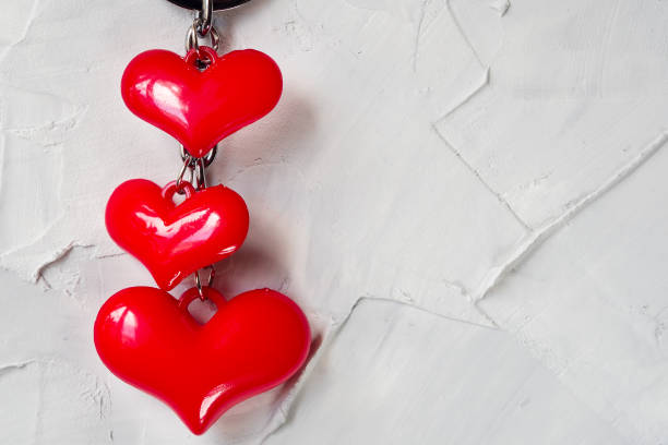 istock Three bright red hearts on the gray concrete background. 947092462