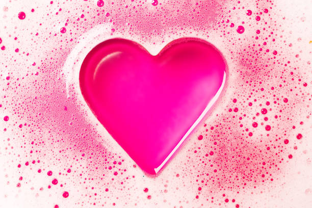 istock Heart from a foam on a pink background. 947092534