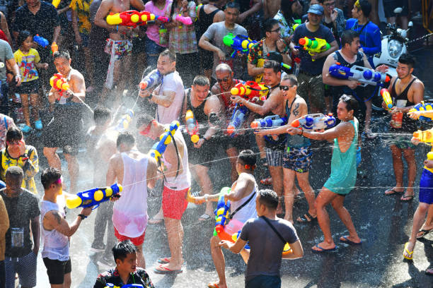 Songkran festival in Bangkok ,Thailand People happy and funny playing water in Songkran festival at Silom Road in Bangkok. silom stock pictures, royalty-free photos & images