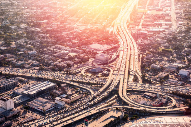 Los Angeles Freeway Rush Hour Heavy traffic congestion at the Interstate 10 and 101 interchange near downtown Los Angeles, California at sunset. los angeles traffic jam stock pictures, royalty-free photos & images