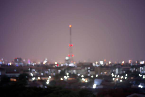 blur bokeh or defocused of light from tower bright in night city for background. night cityscape concept.