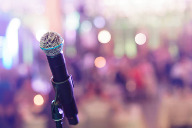 istock Close up microphone on stage in concert hall restaurant or conference room. Blurred background. Copy space 947102488
