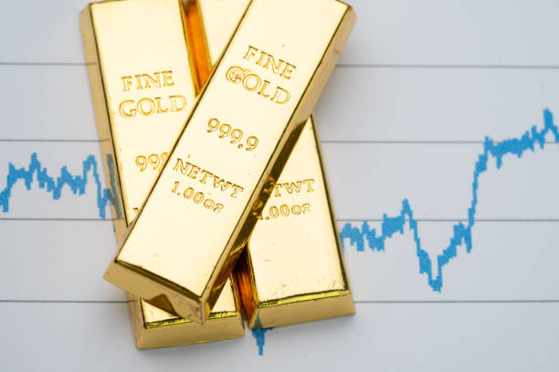 Gold bar, bullion stack on rising price graph as financial crisis or war safe haven, financial asset, investment and wealth concept stock photo