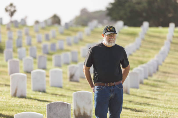 istock Authentic Vietnam Veteran Walking in Military Cemetary 947103748