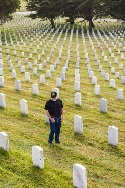istock Authentic Vietnam Veteran Walking in Military Cemetary 947103756