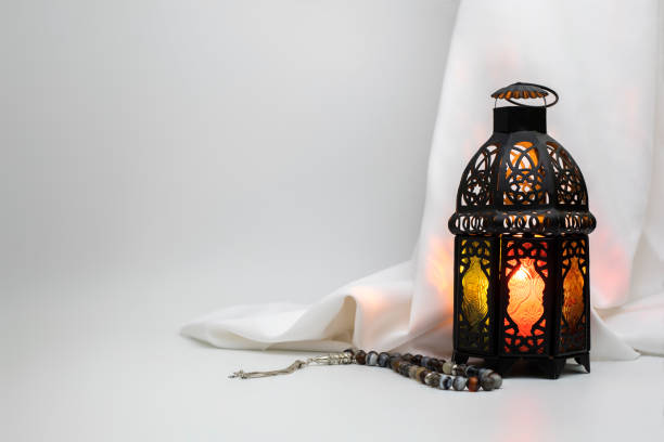 istock Lantern and prayer beads beads with satin cloth in the background 947110844