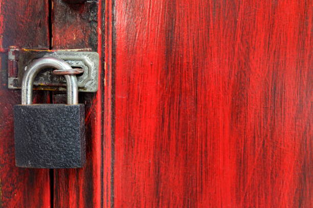 istock Black Lock on Red Wood Door. 947111414