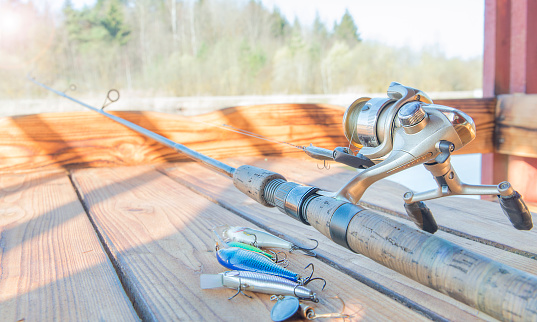 Catchy fishing lures on a wooden table.