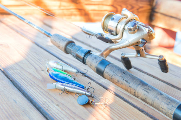 istock Catchy fishing lures on a wooden table. 947112098