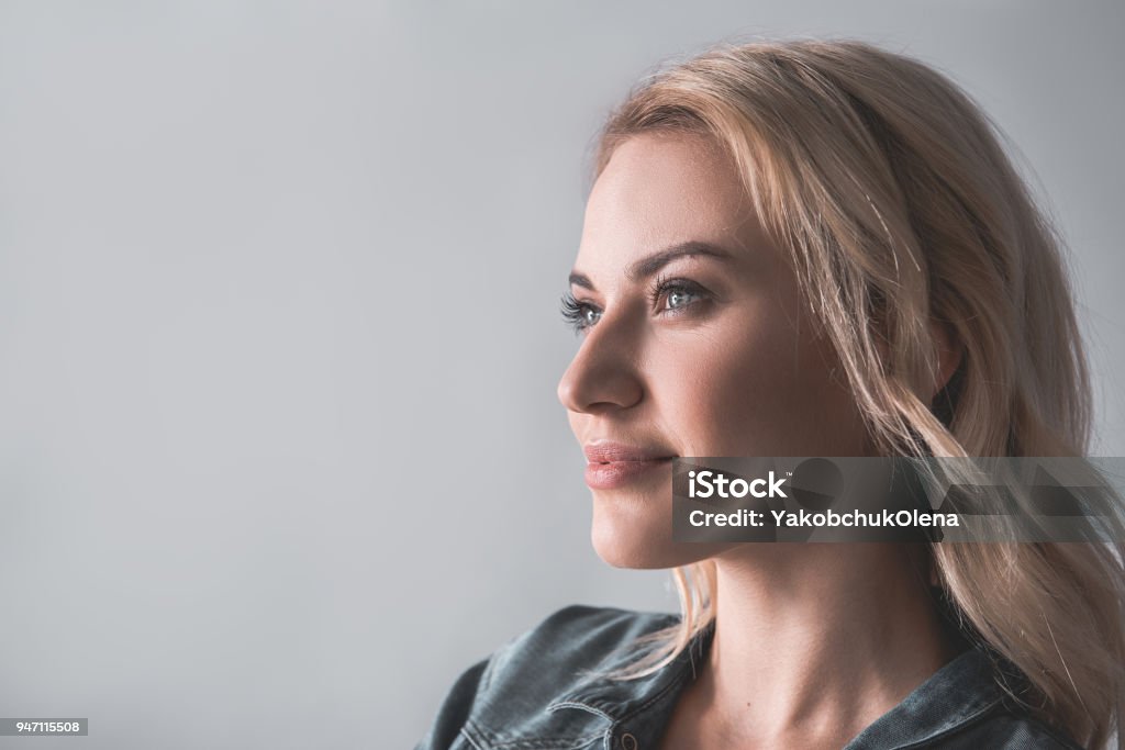 Female student lost in thoughts Profile of pensive woman with blonde hair looking aside. Copy space in left side. Isolated on background Women Stock Photo