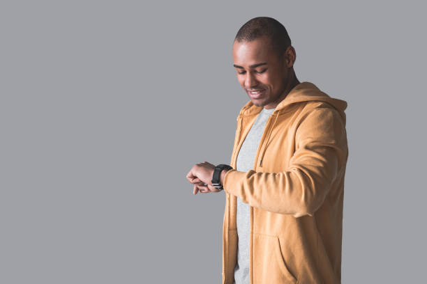 istock African guy staring at his hand watch 947115734