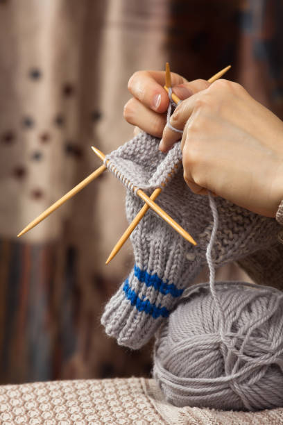istock hands of woman knitting a sock with bamboo needles 947127322