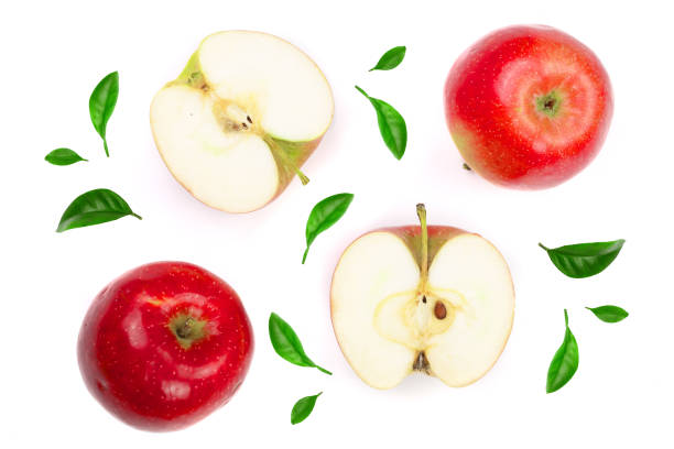 istock red apples with slices decorated with green leaves isolated on white background top view. Flat lay pattern 947127518