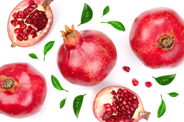 istock pomegranate with leaves isolated on white background. Top view. Flat lay pattern 947127590