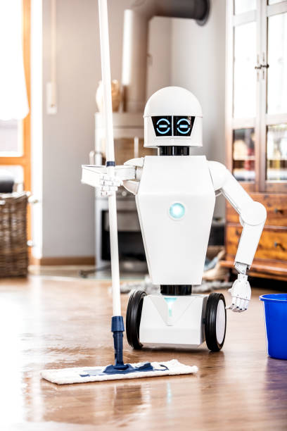 istock automatic robot floor scrubber is doing his work in an living room, vertical shot with copyspace 947127750